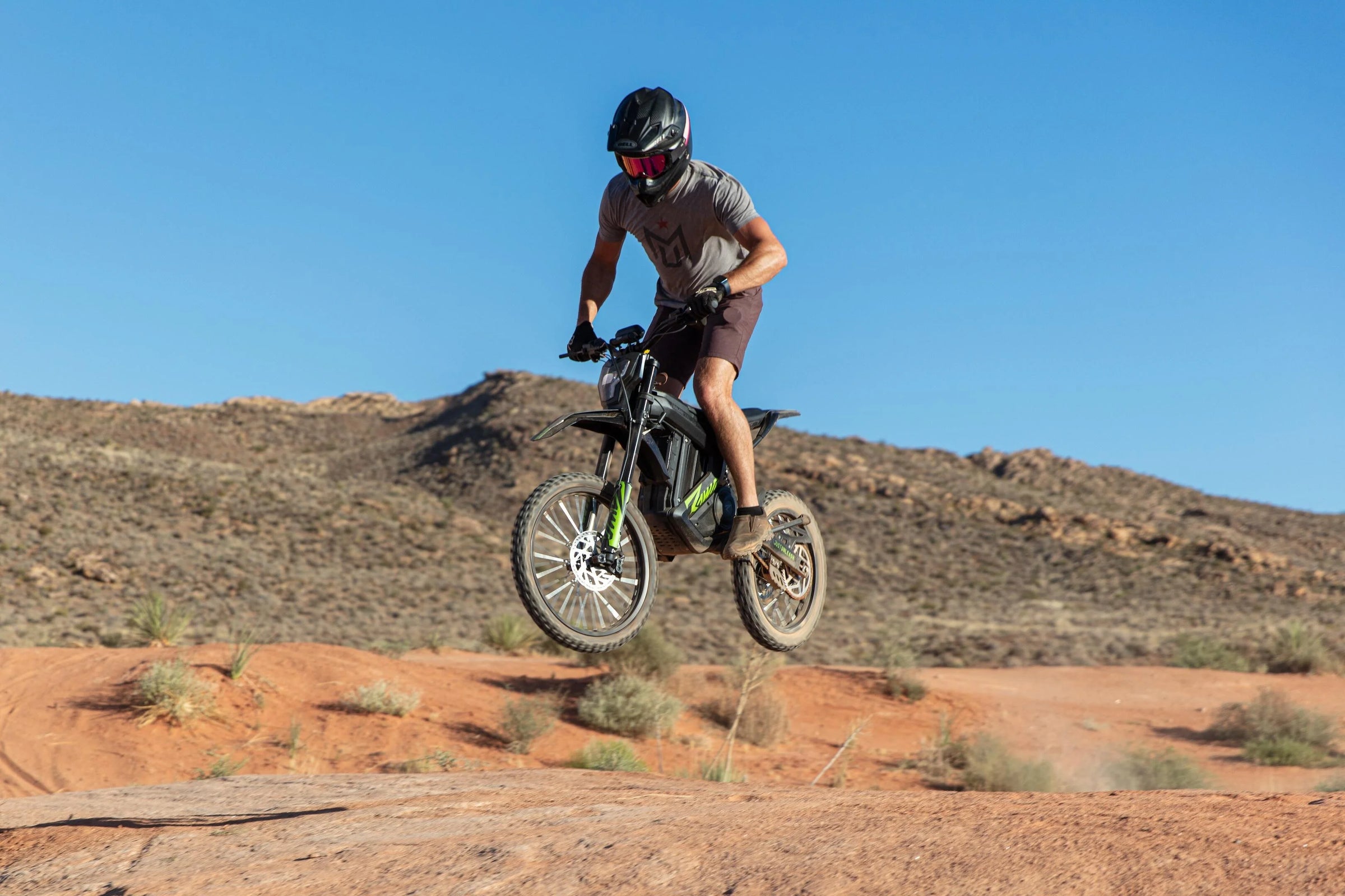 Rider jumps with a rawrr mantis model on an open fround.