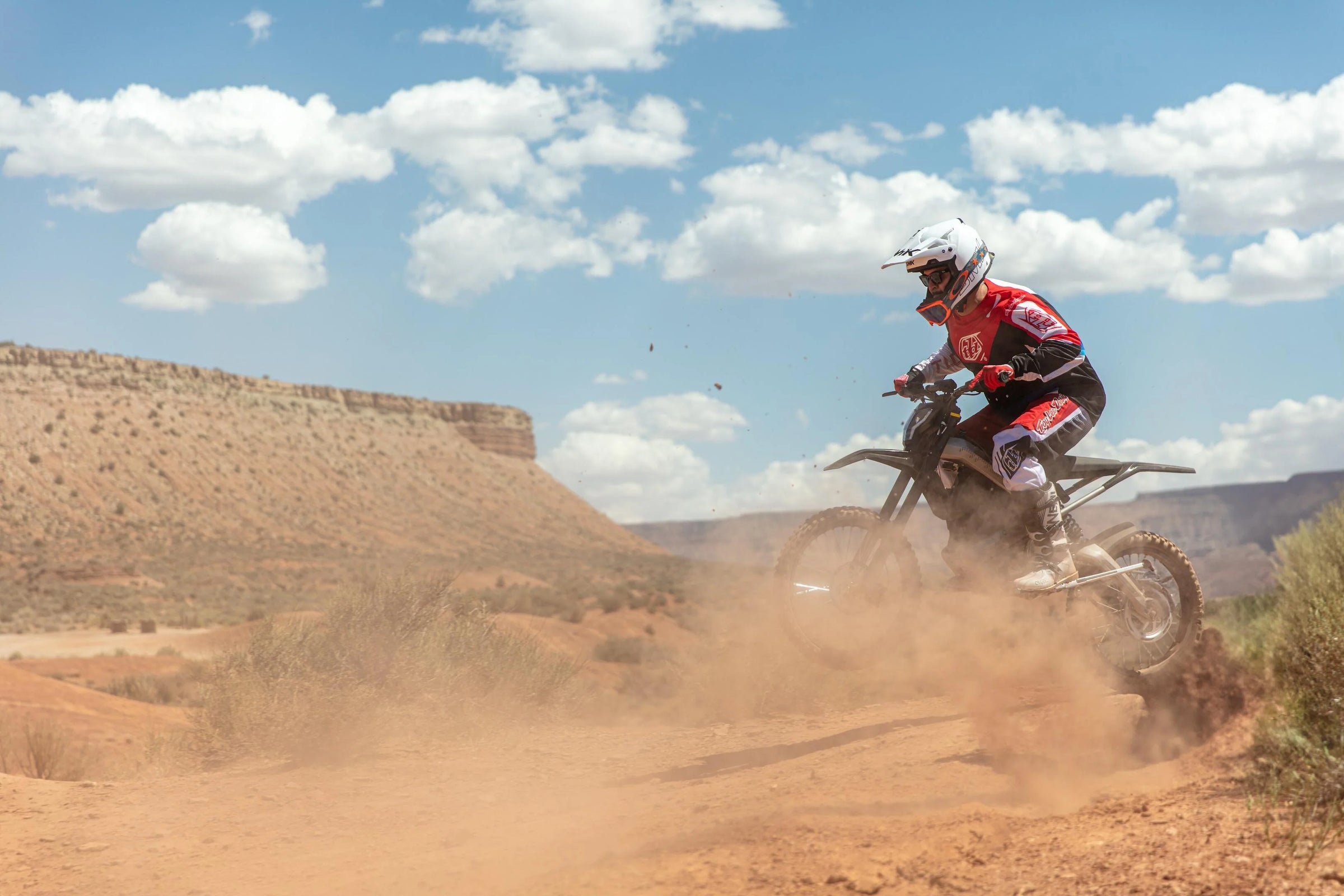 A rider riding on a RAWRR Mantis model in the desert.