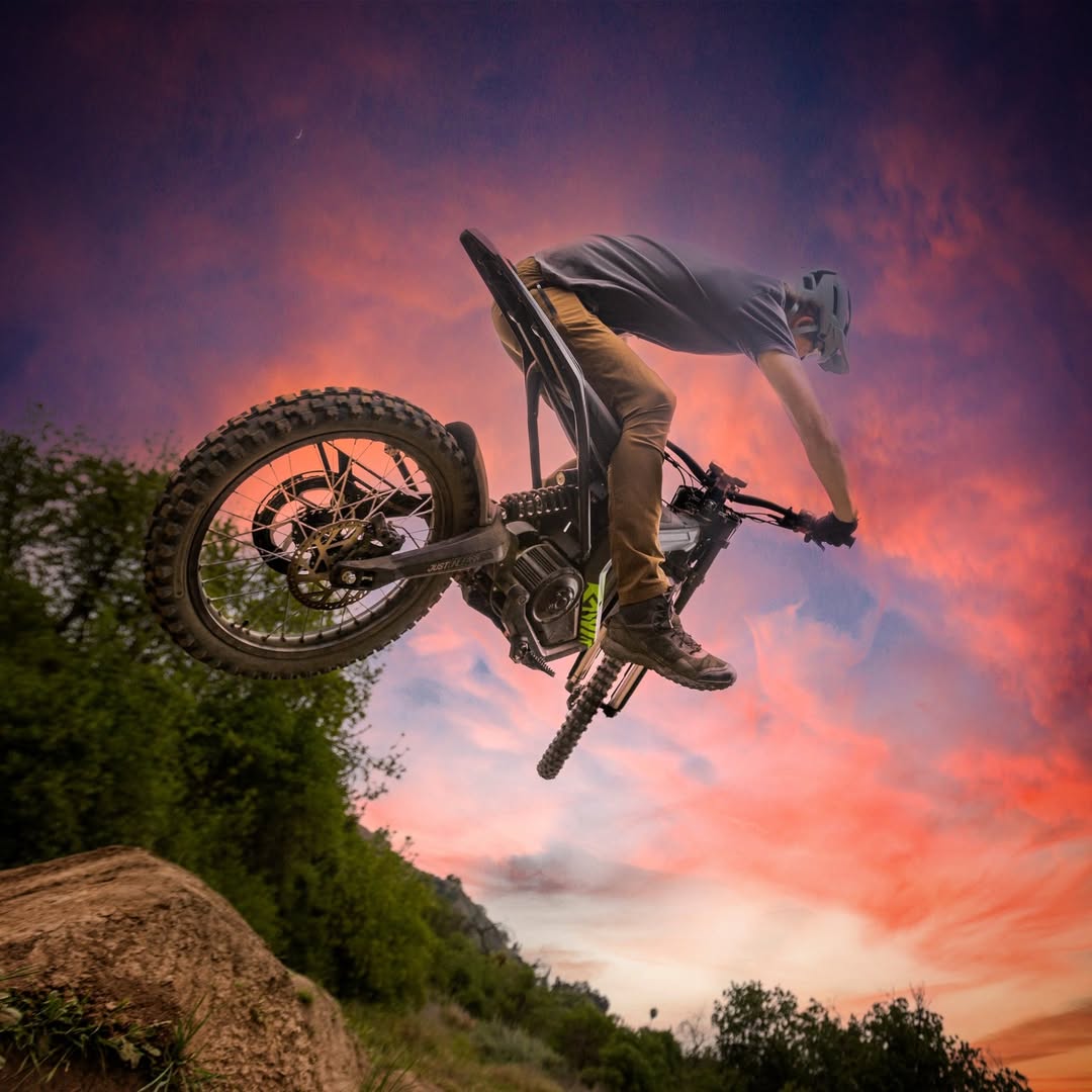 A rider jumps up with rawrr mantis x model with beautiful clouds as a background