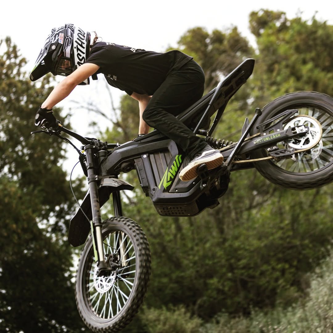 A man jumps with rawrr mantis x model in a yard