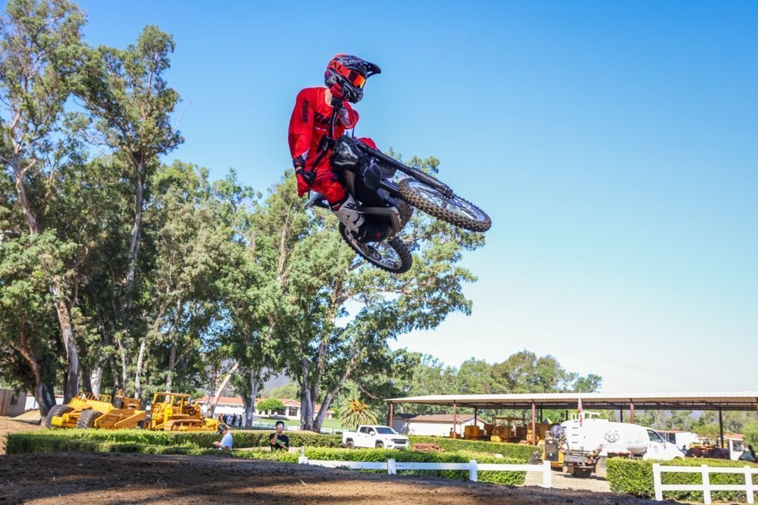 Rider jumps high with a rawrr mantis in a play ground