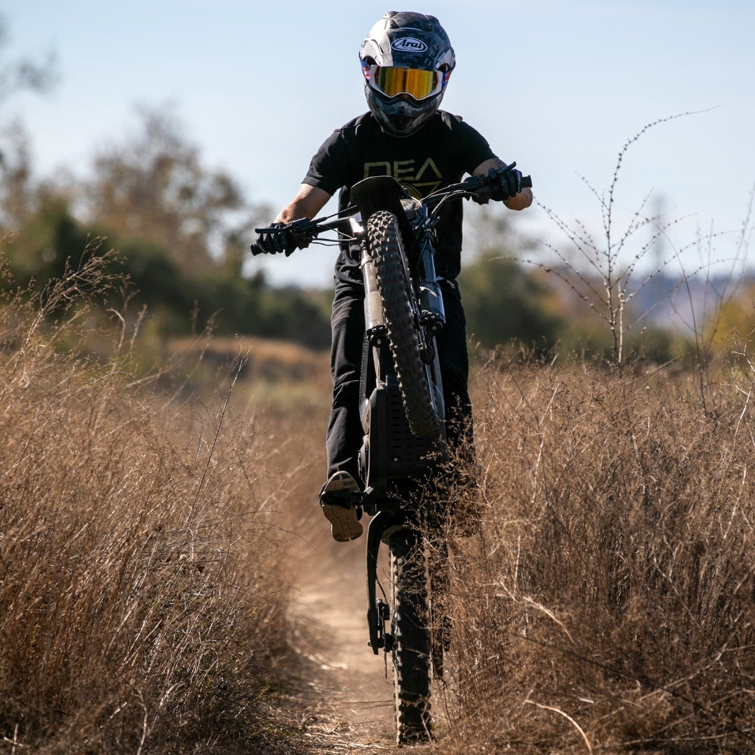 Rider is heading up with a black rawrr mantis bike