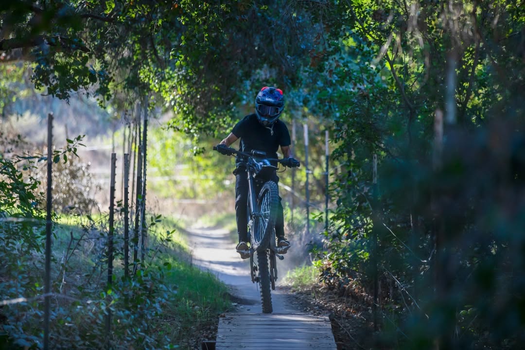 A rider is riding a rawrr mantis on a small road